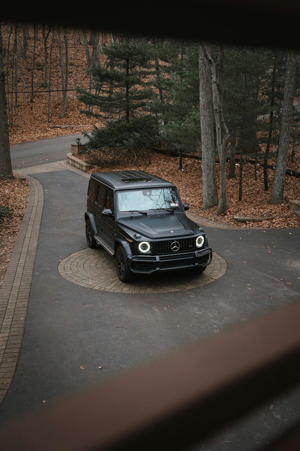 a black suv is parked on the side of the road