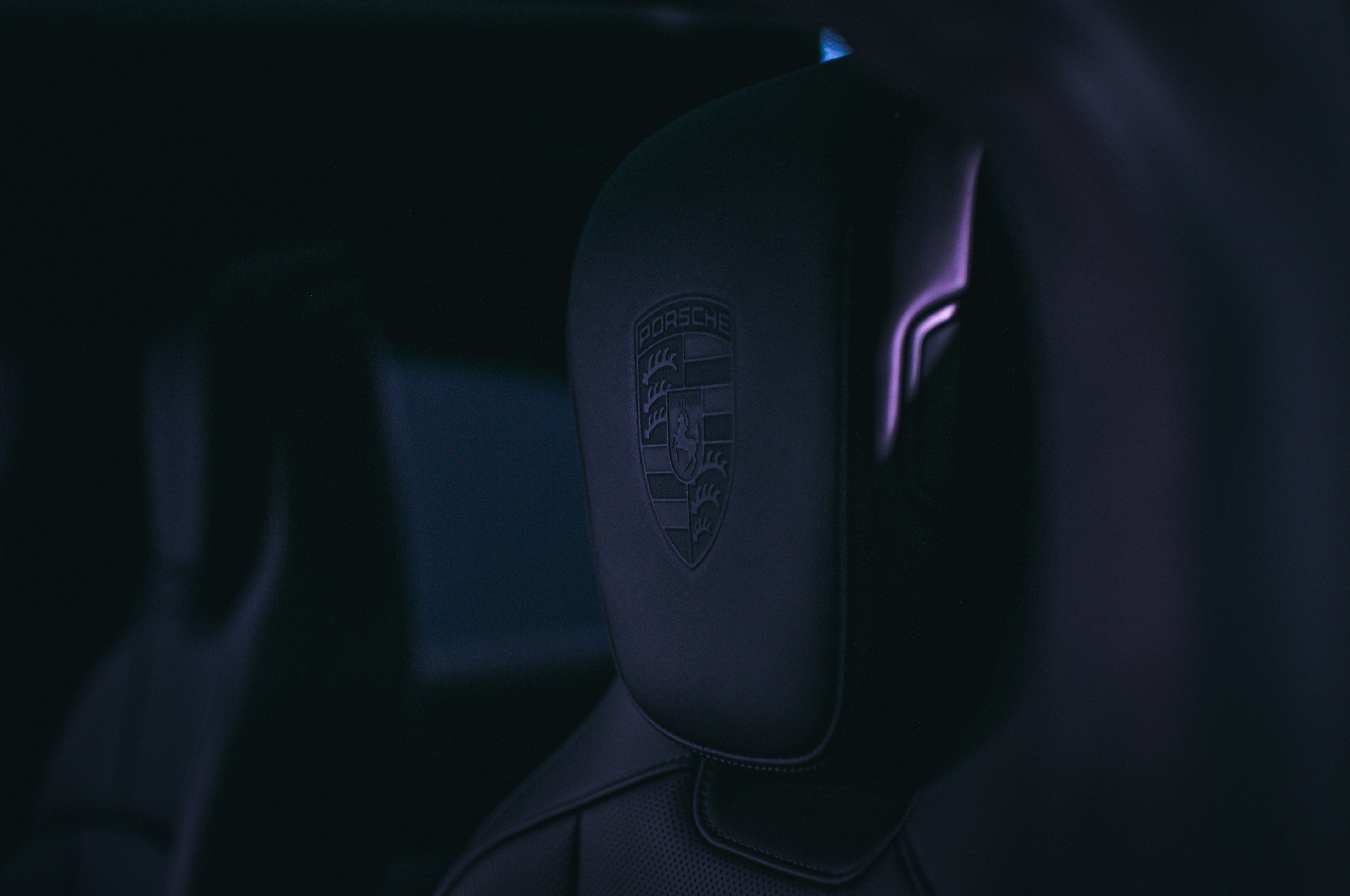 Person designing AI chatbot persona on laptop with creative tools