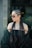 a woman with long dreadlocks wearing a black dress