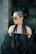 a woman with long dreadlocks wearing a black dress