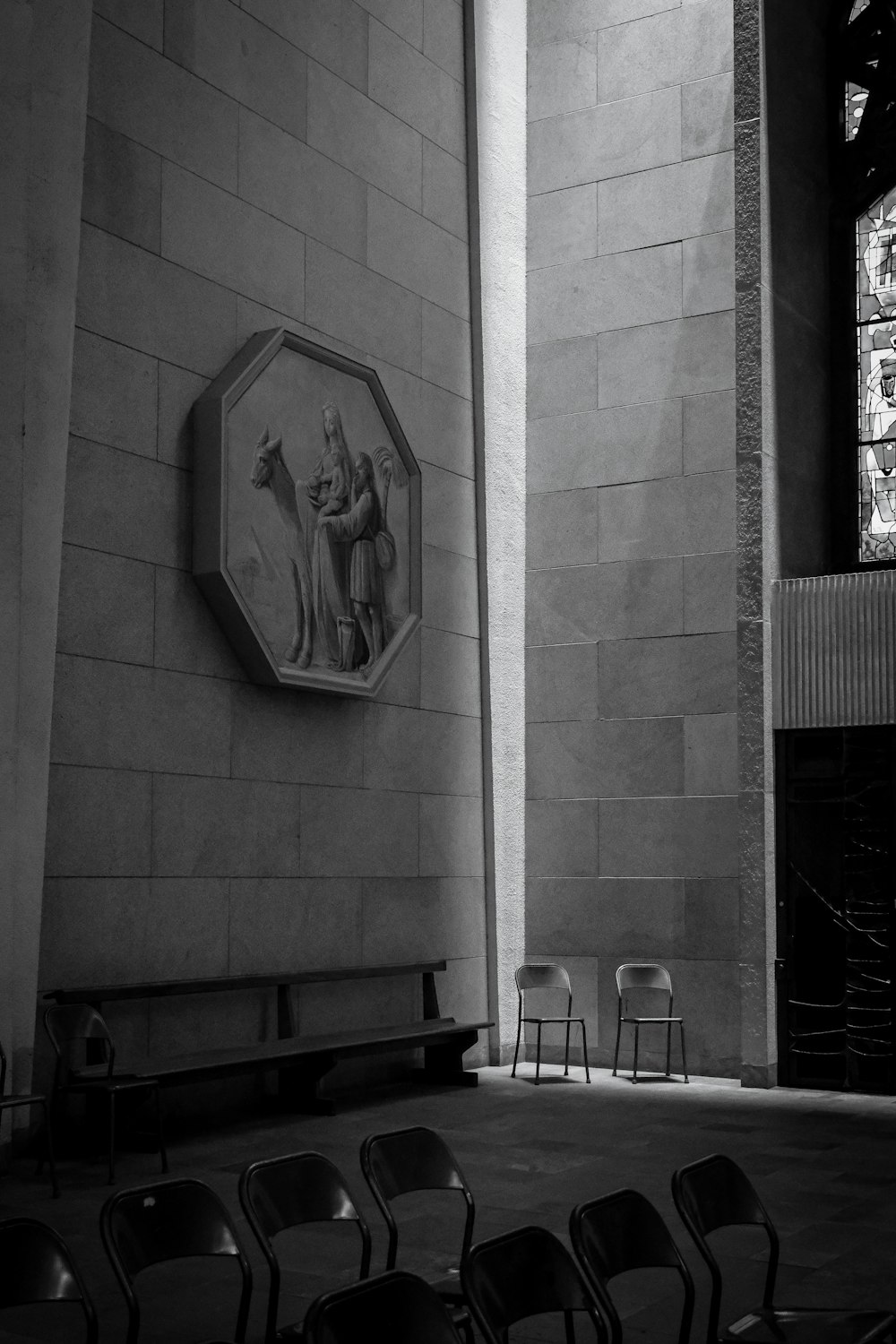 a black and white photo of a room with chairs