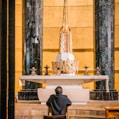 a man sitting in a chair in a church