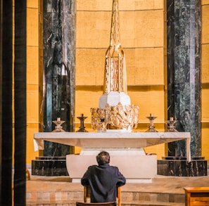 a man sitting in a chair in a church