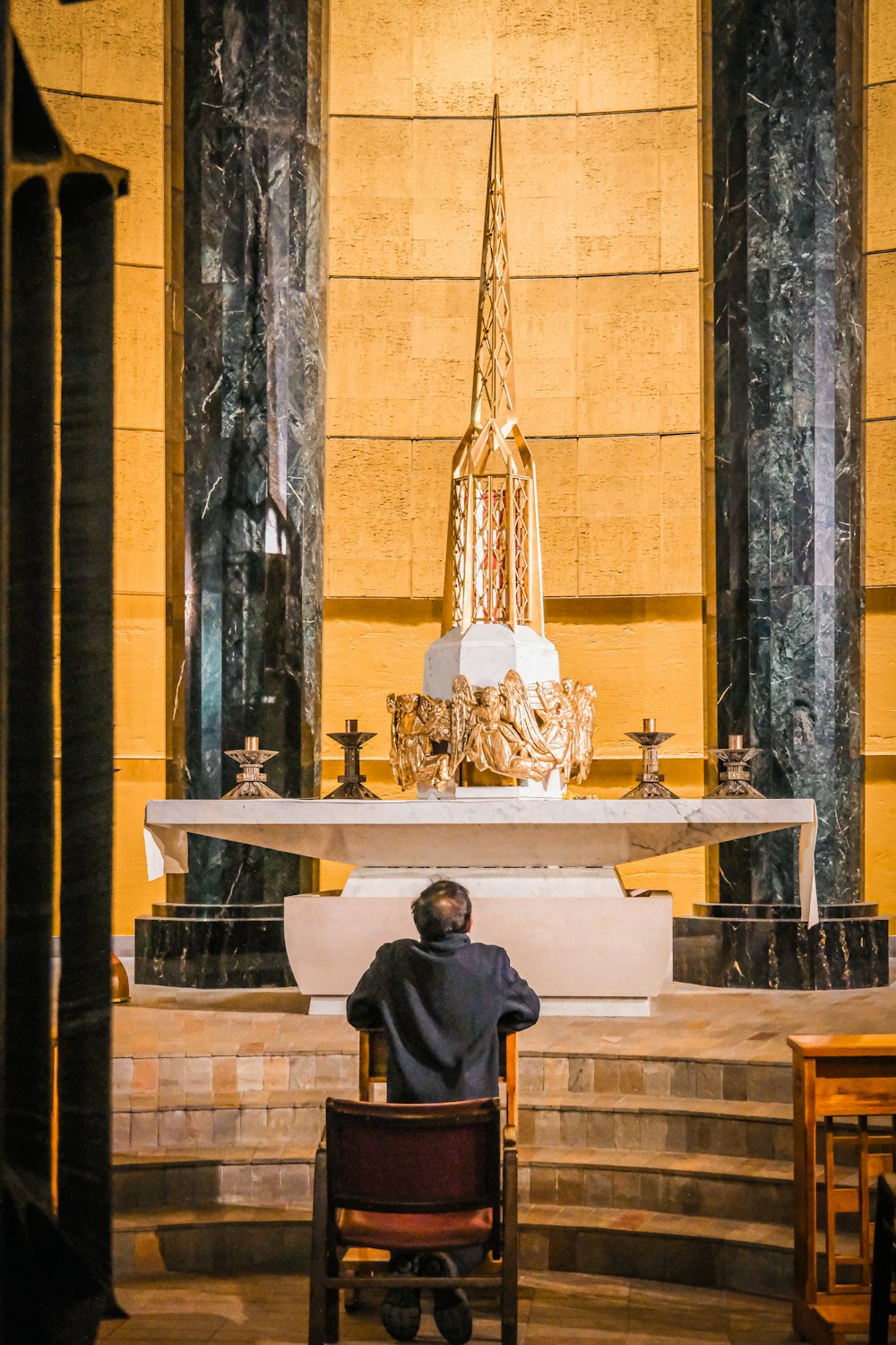 a man sitting in a chair in a church