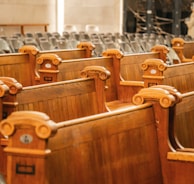 rows of wooden seats in a large auditorium