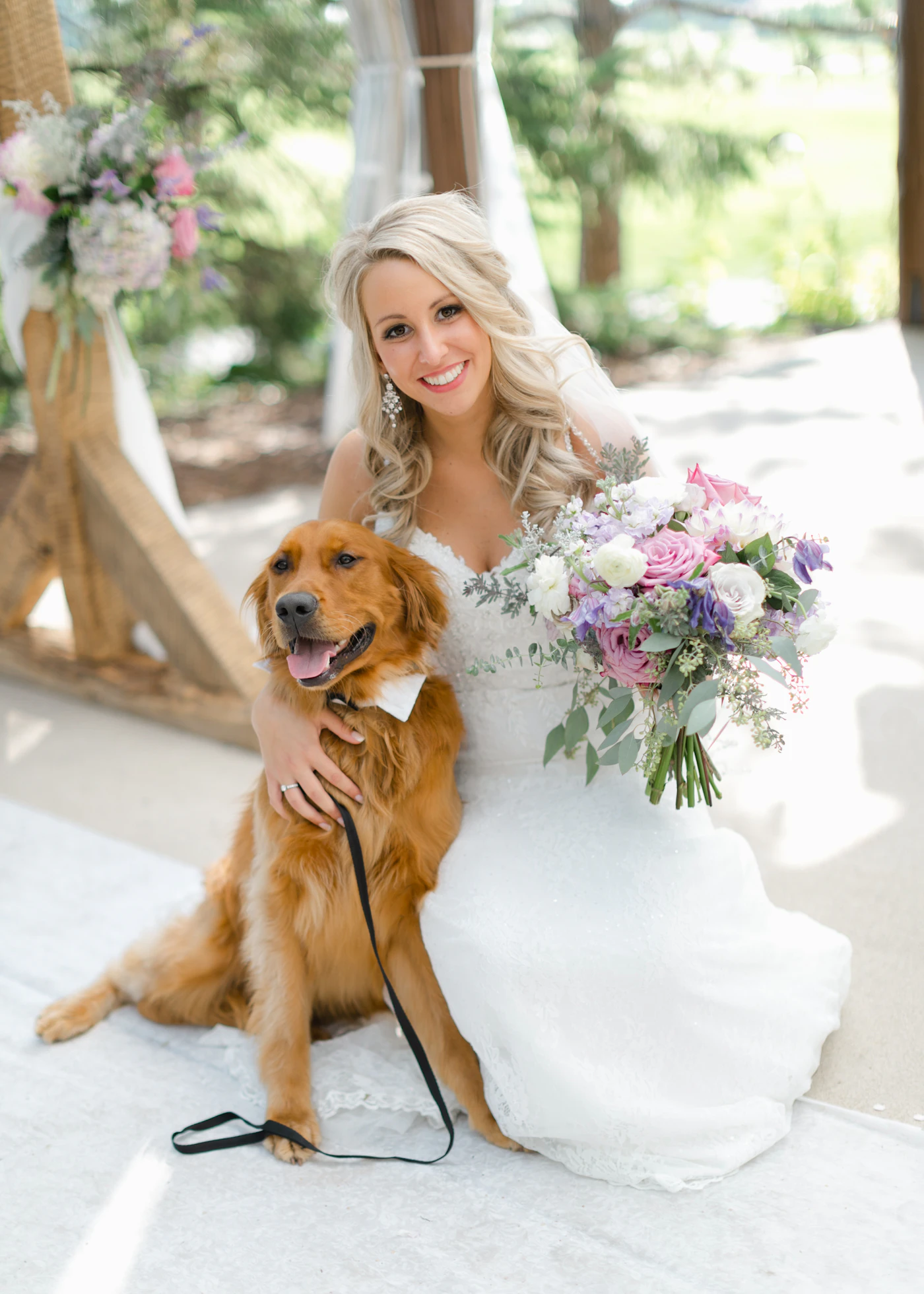 Pet-friendly wedding ceremony ideas and safety tips — A dog wearing a floral collar walks down the aisle at an outdoor wedding.