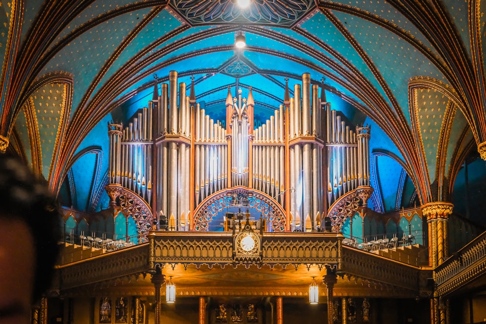 a large pipe organ in a church with a clock