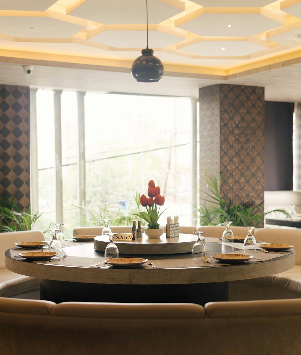 a dining room with a round table and chairs