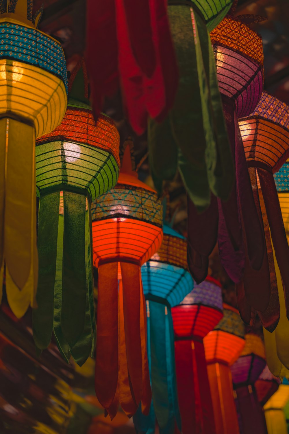 a bunch of colorful lights hanging from a ceiling