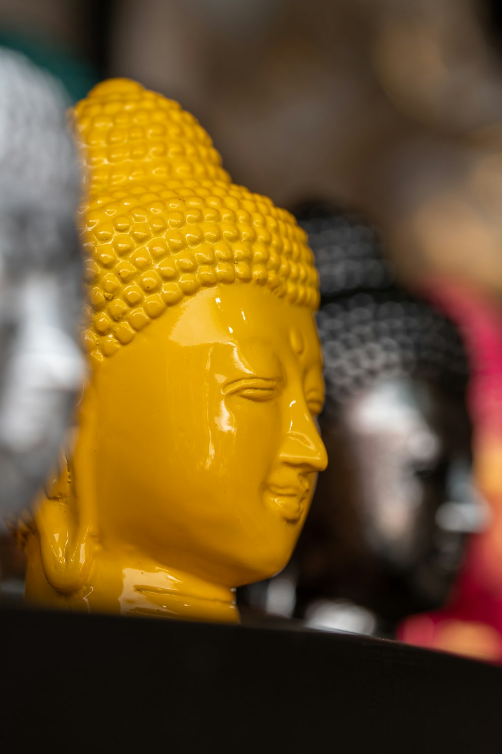 a yellow buddha statue sitting on top of a table