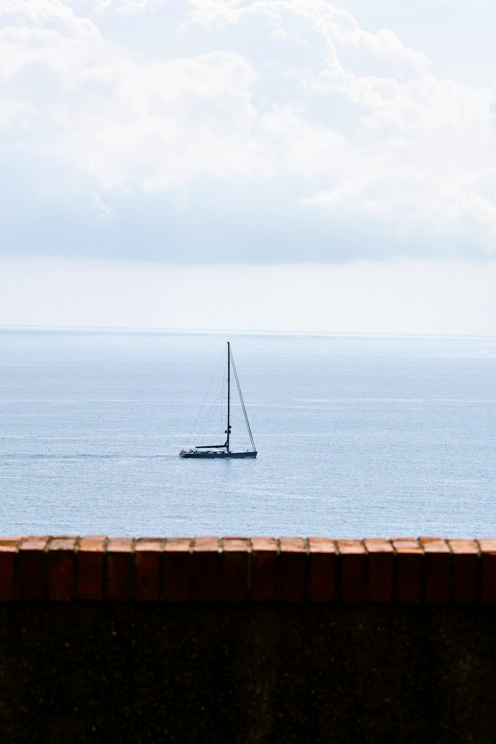 a sailboat in the middle of the ocean