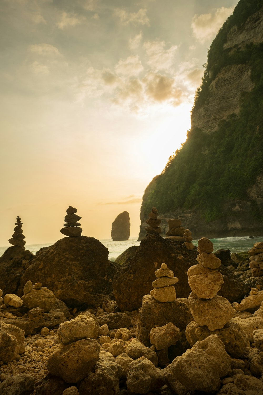 a group of rocks sitting on top of a beach