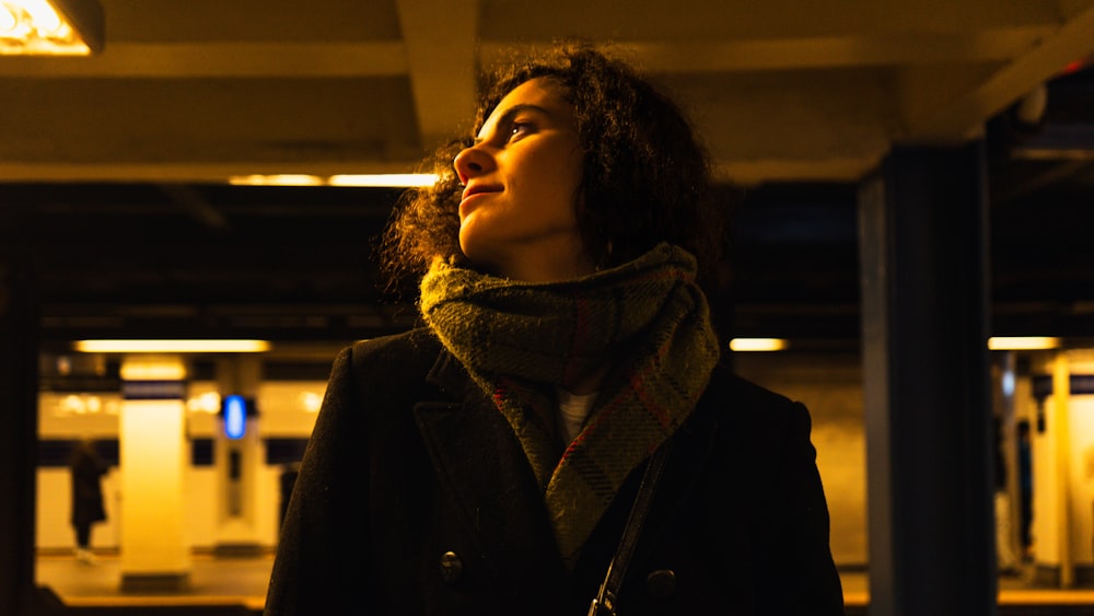 a woman standing in a parking garage with her eyes closed