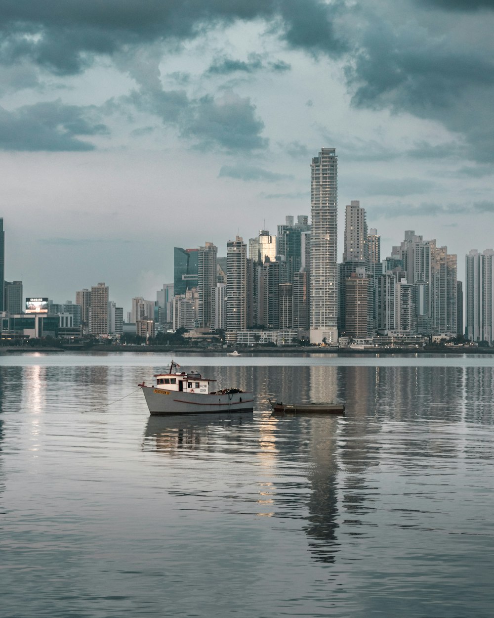 a couple of boats floating on top of a large body of water