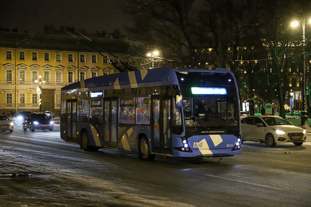 a bus driving down a street at night