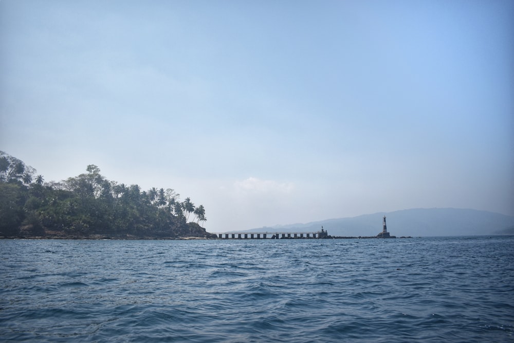 a body of water with a small island in the background