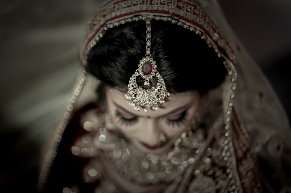 a woman in a bridal dress with a veil on her head
