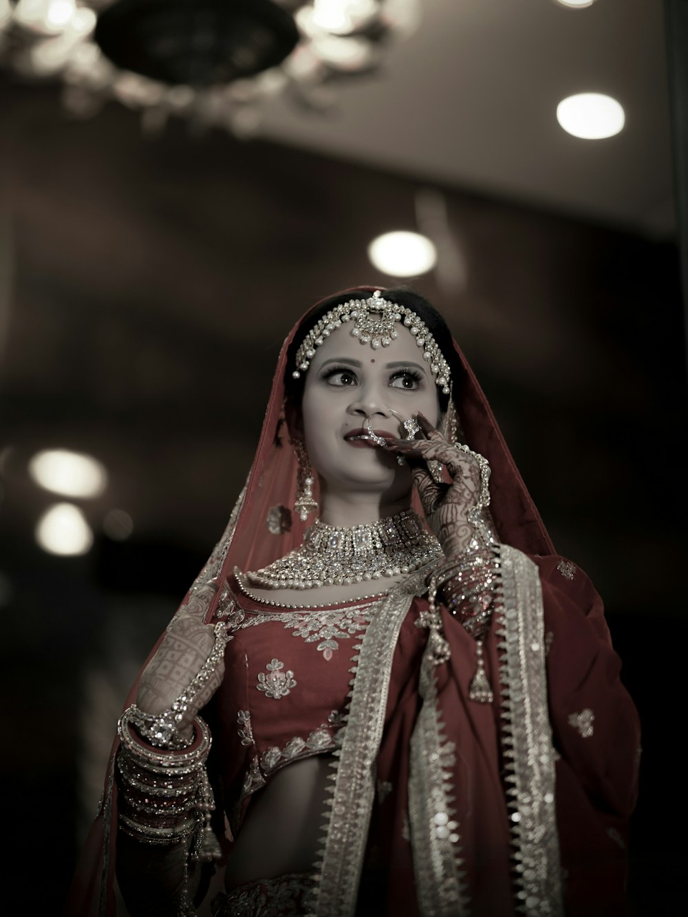 a woman in a red and white bridal outfit