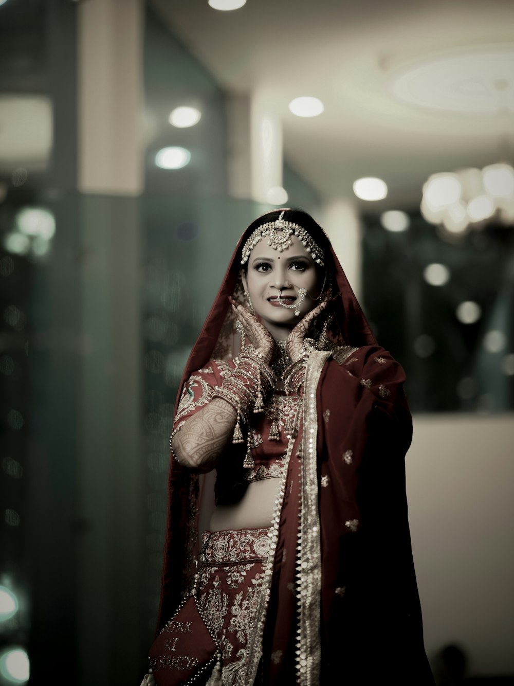 a woman in a red and white bridal outfit