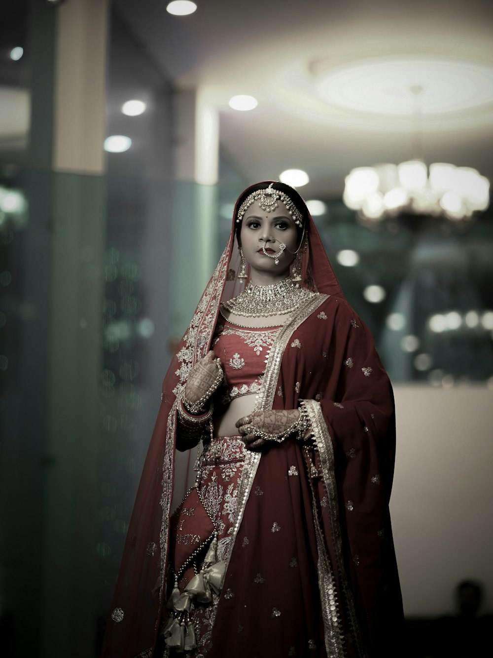 a woman in a red and gold bridal gown
