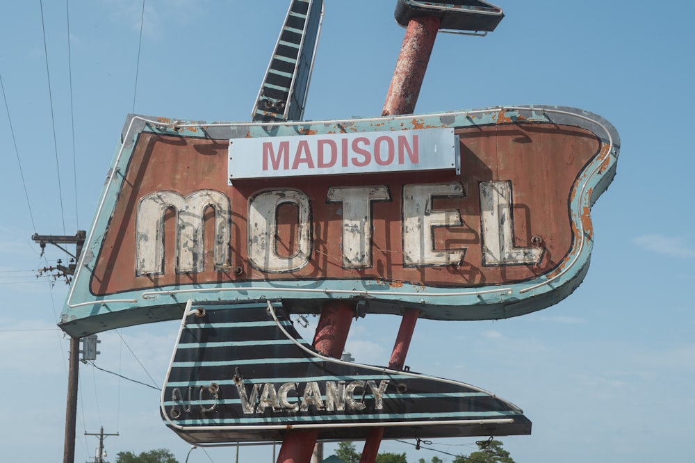 a neon sign for a motel with a giraffe on top of it