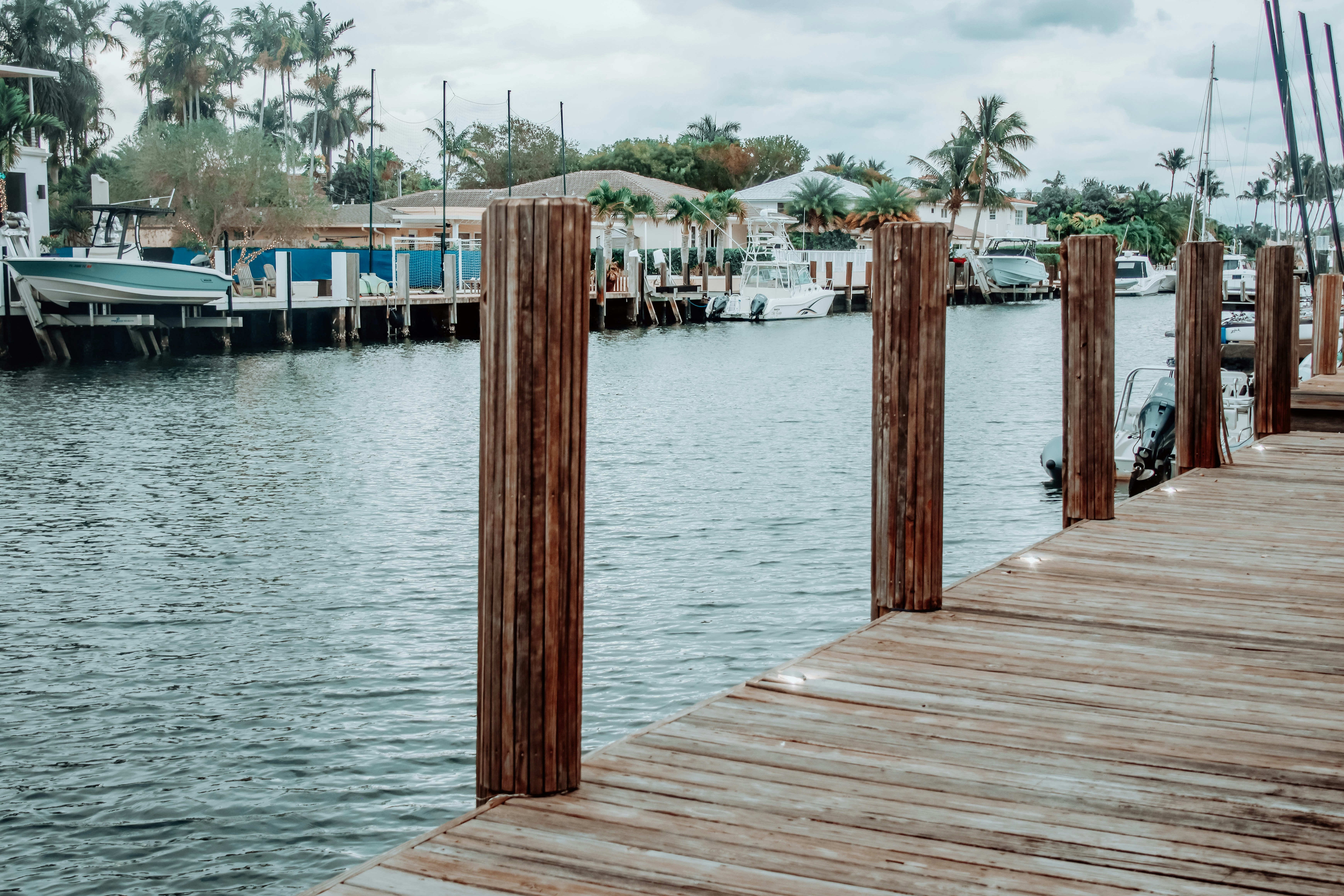 a wooden dock with a boat in the water