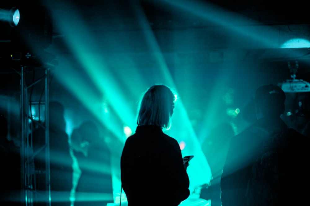 a man standing in front of a green light