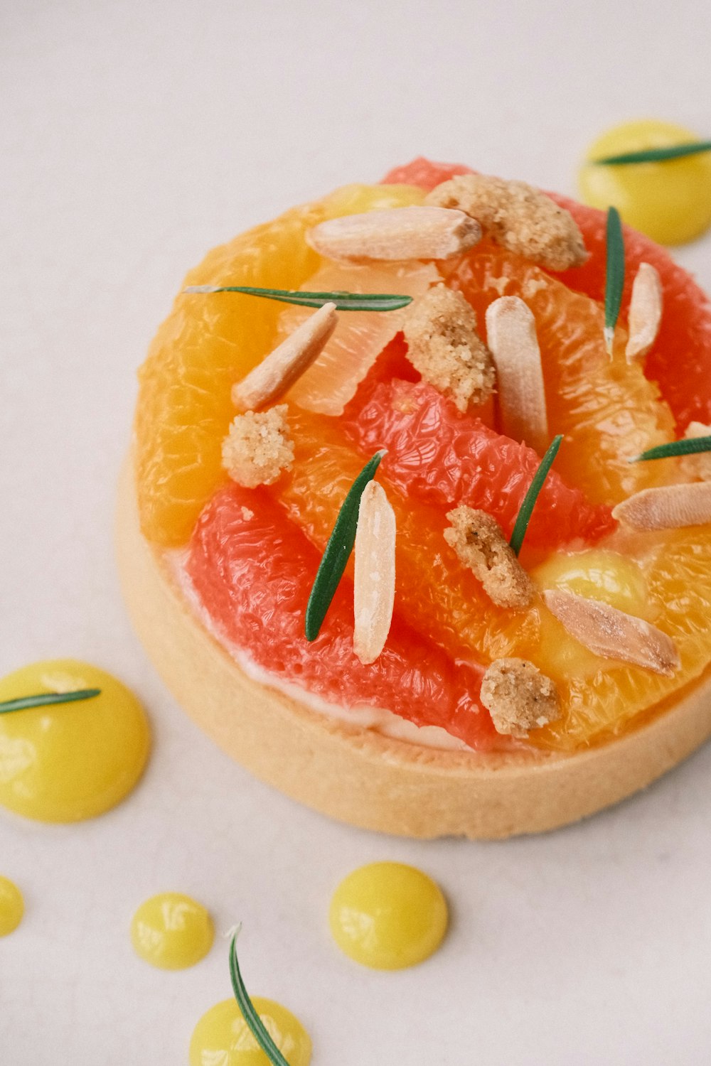 a pastry with oranges and almonds on it