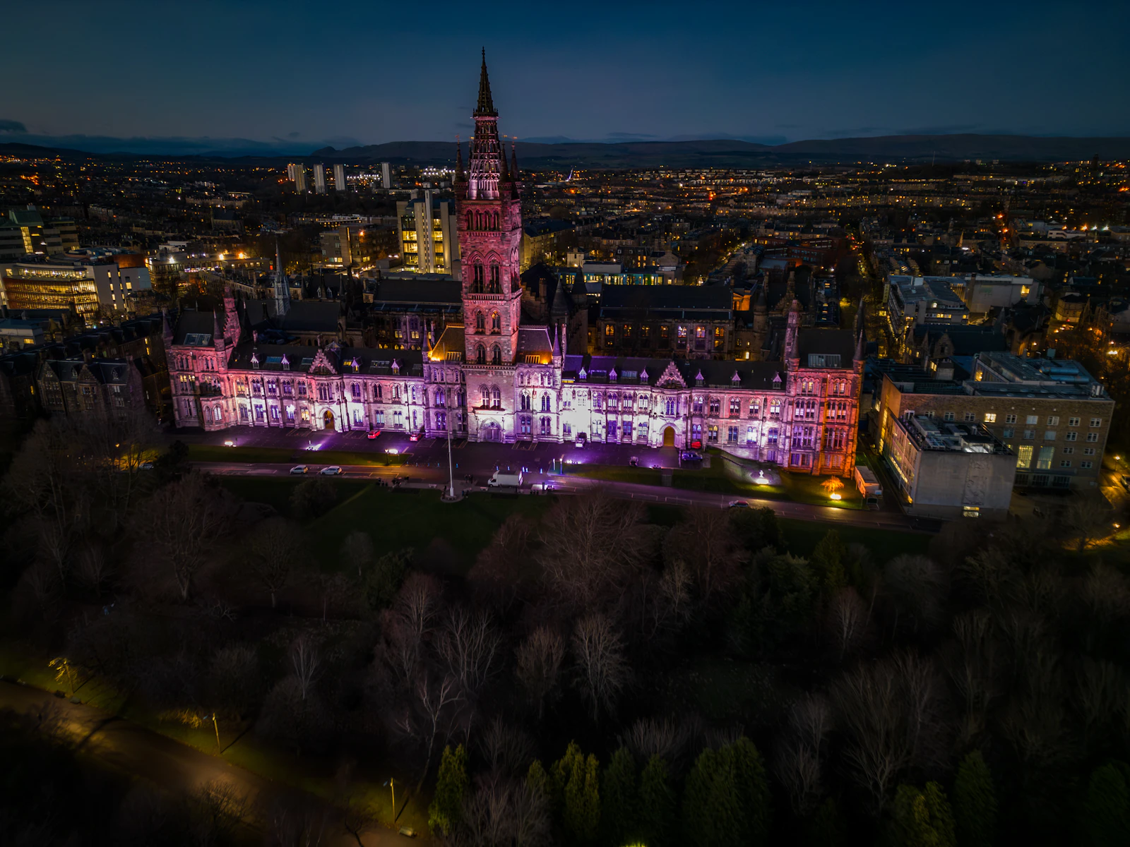 The University of Glasgow's Gothic main building and tower lit up at twilight