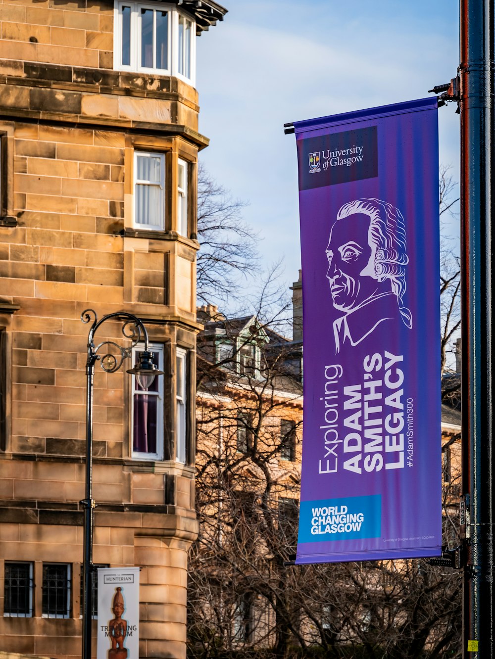 a purple banner hanging off the side of a building