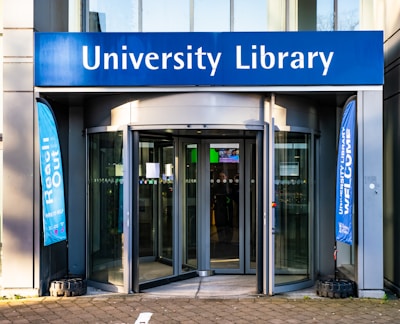 a university library entrance with a bicycle parked in front of it