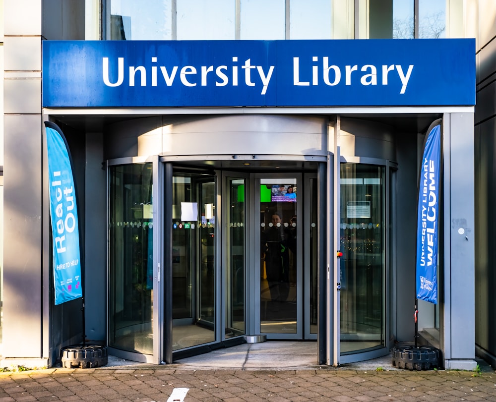 a university library entrance with a bicycle parked in front of it