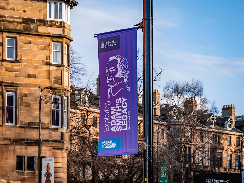 a purple banner hanging from the side of a building