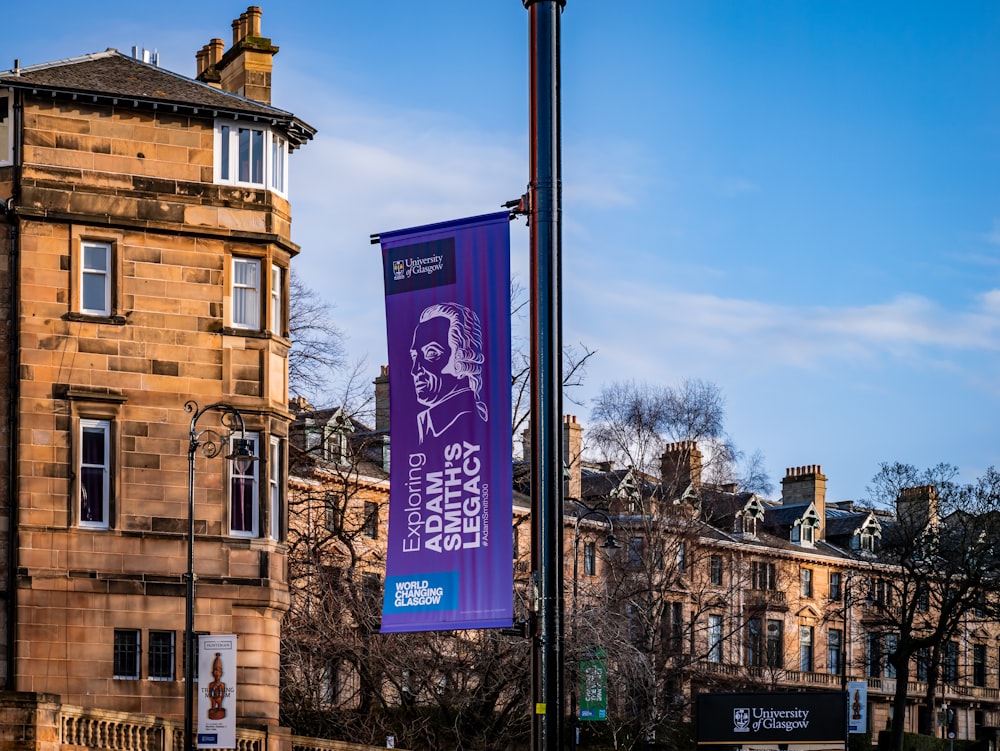 a purple banner hanging from the side of a building