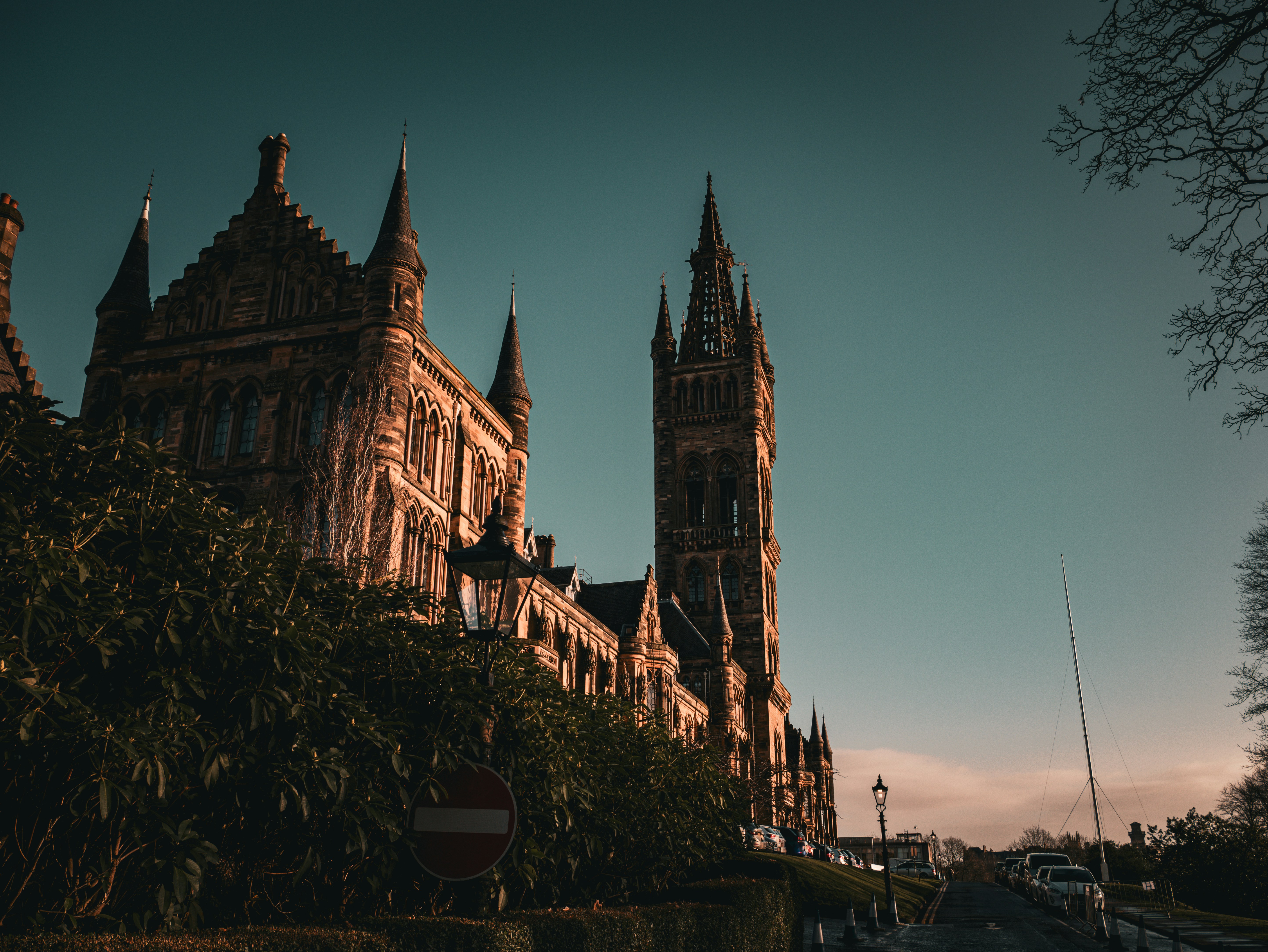 a large building with a clock tower next to a street