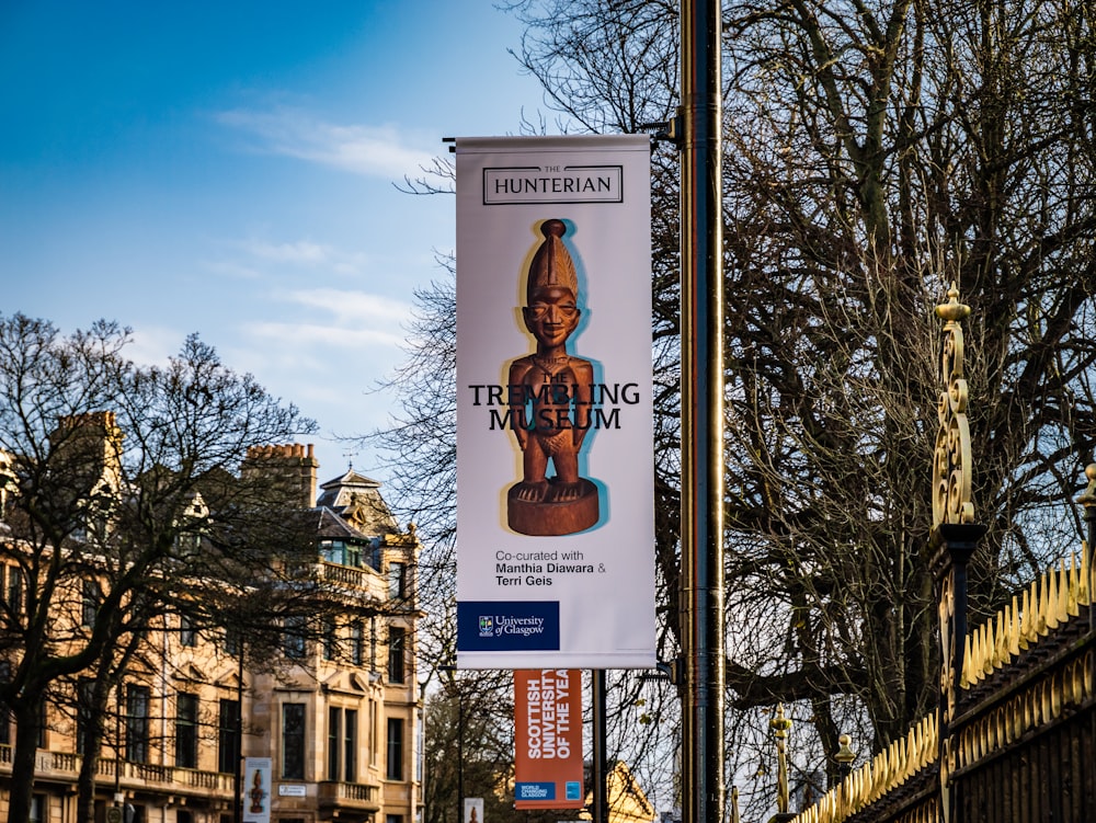 a sign on a pole in front of a building