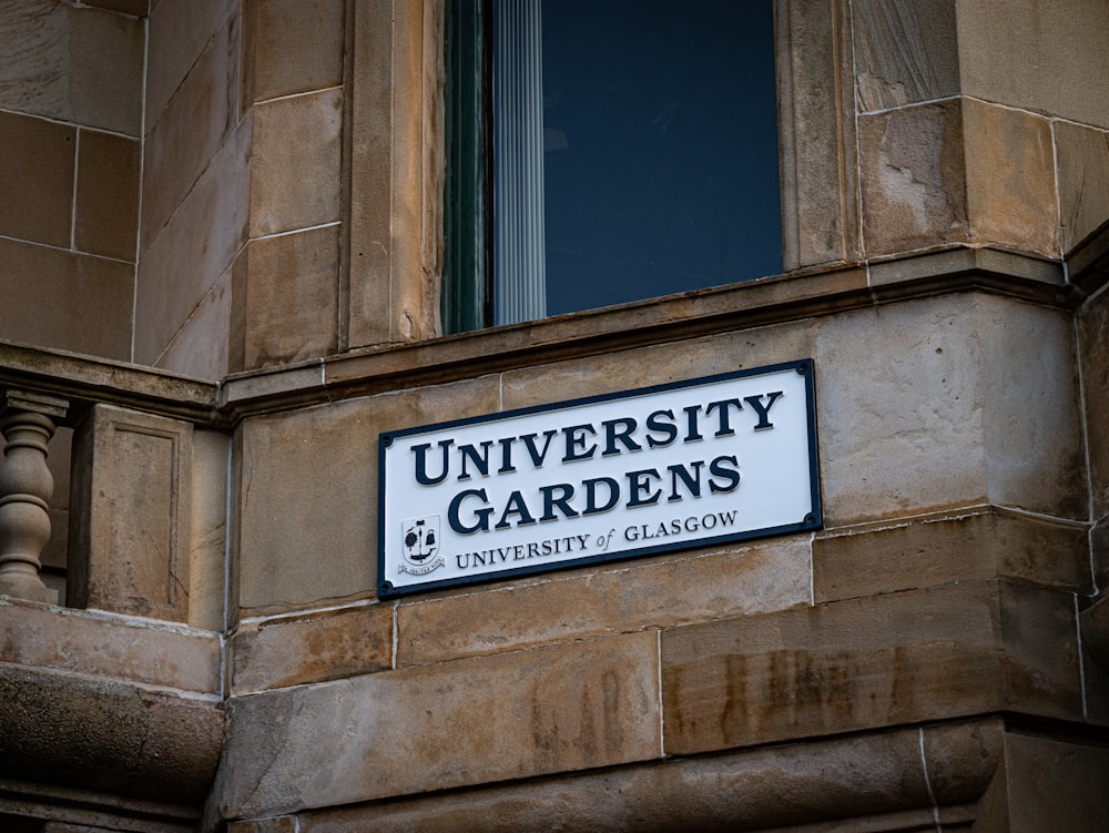 a sign on the side of a building that says university gardens