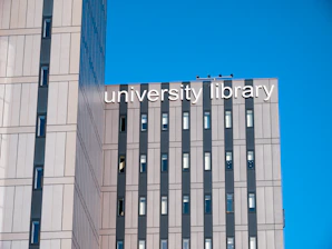 a tall building with a sign that reads university library