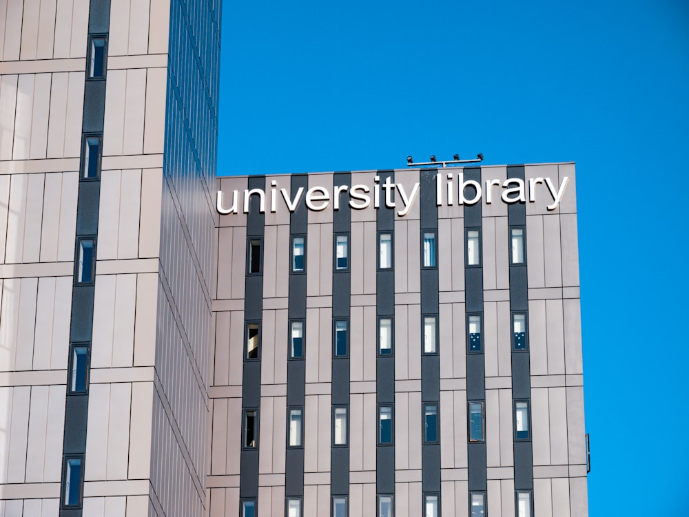 a tall building with a sign that reads university library