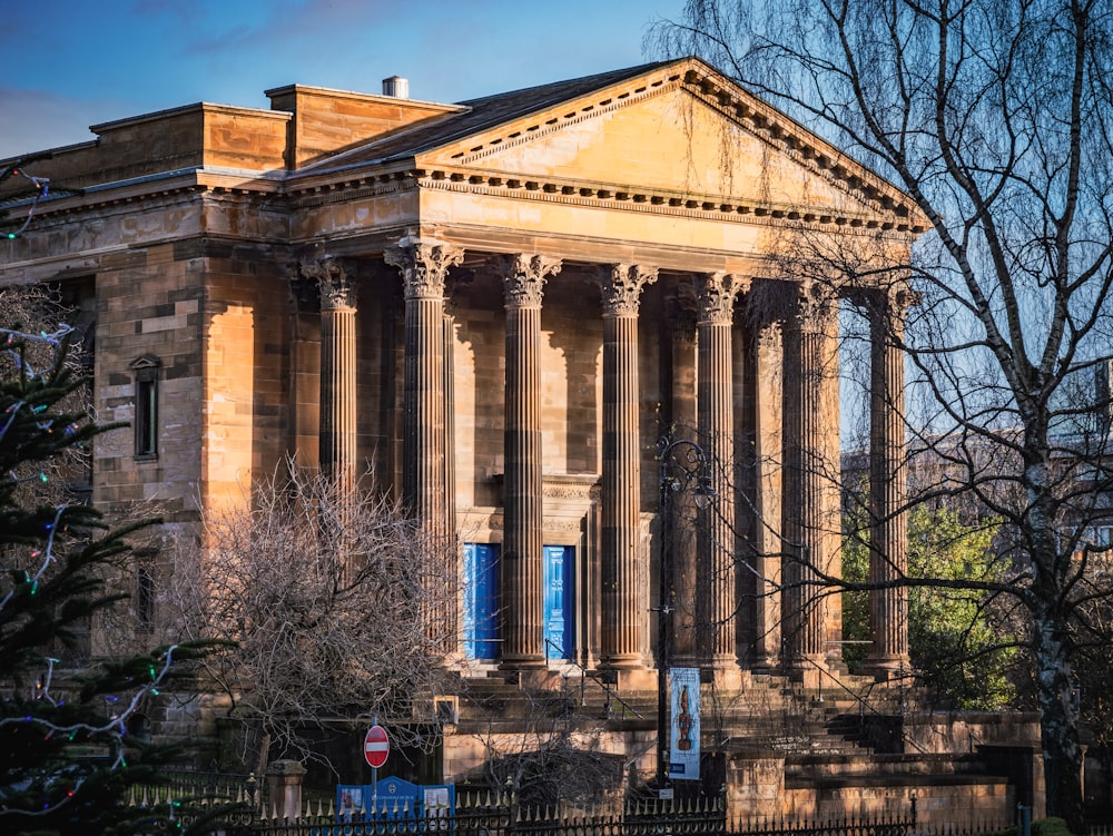 a large building with columns and a clock tower