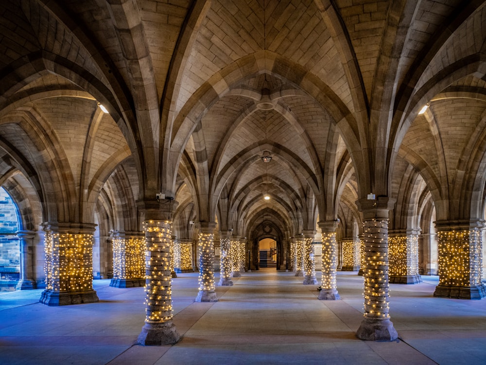 a very large building with columns and lights