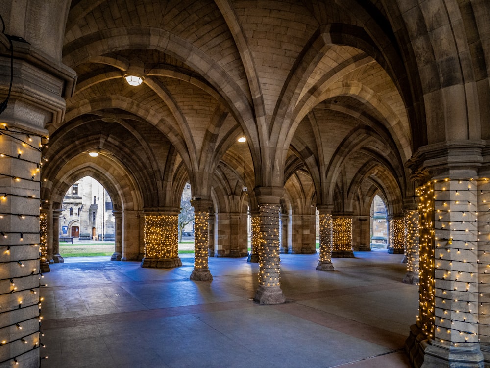 a large room with columns and lights on the walls