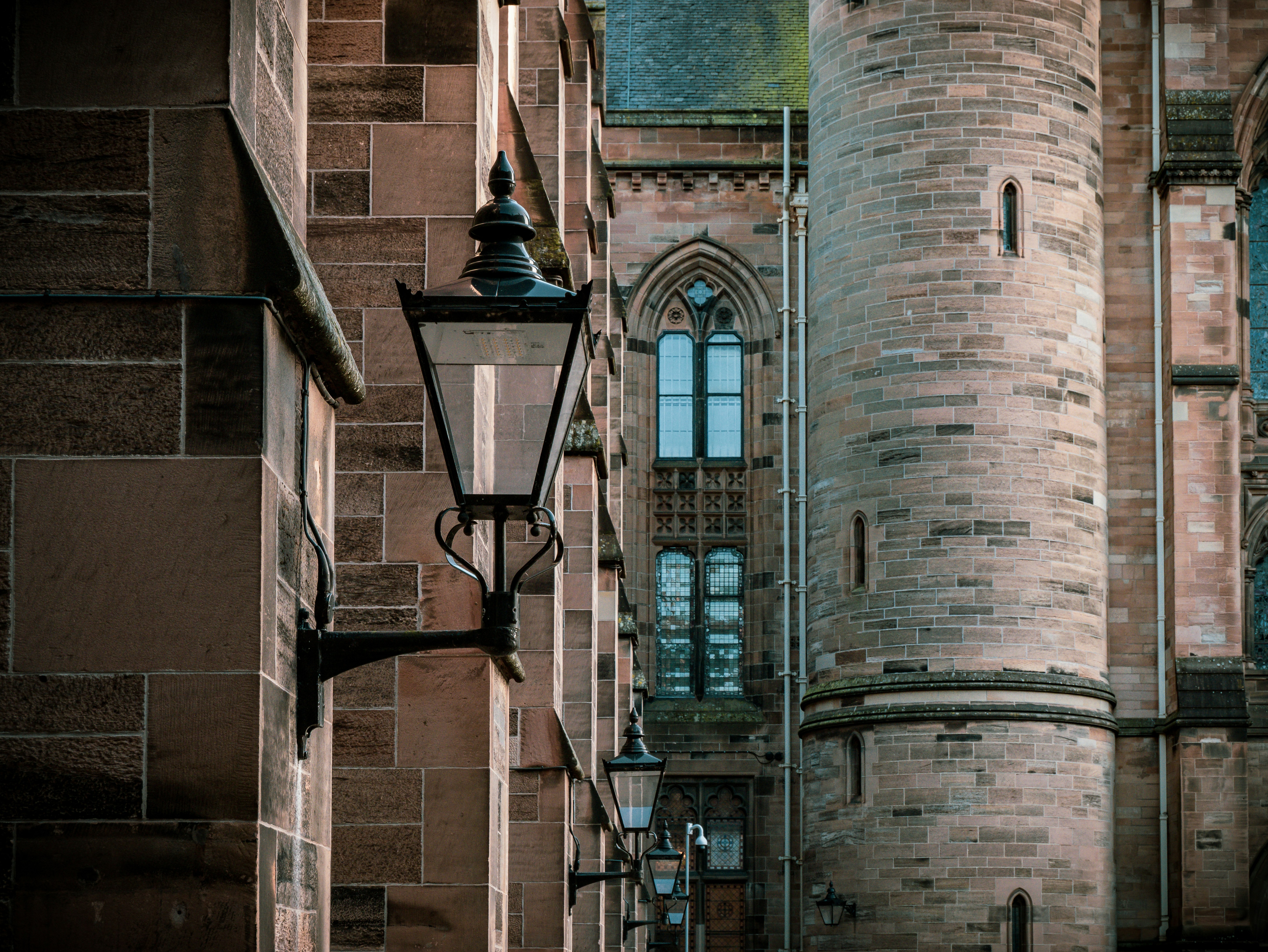 a street light in front of a brick building