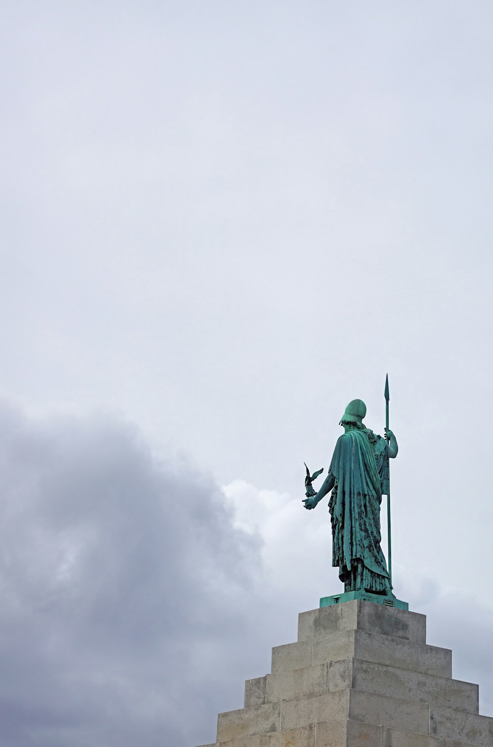 a statue of a man with a sword on top of a building