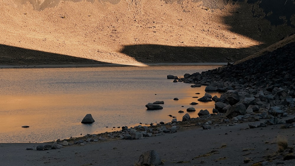 a body of water surrounded by mountains and rocks