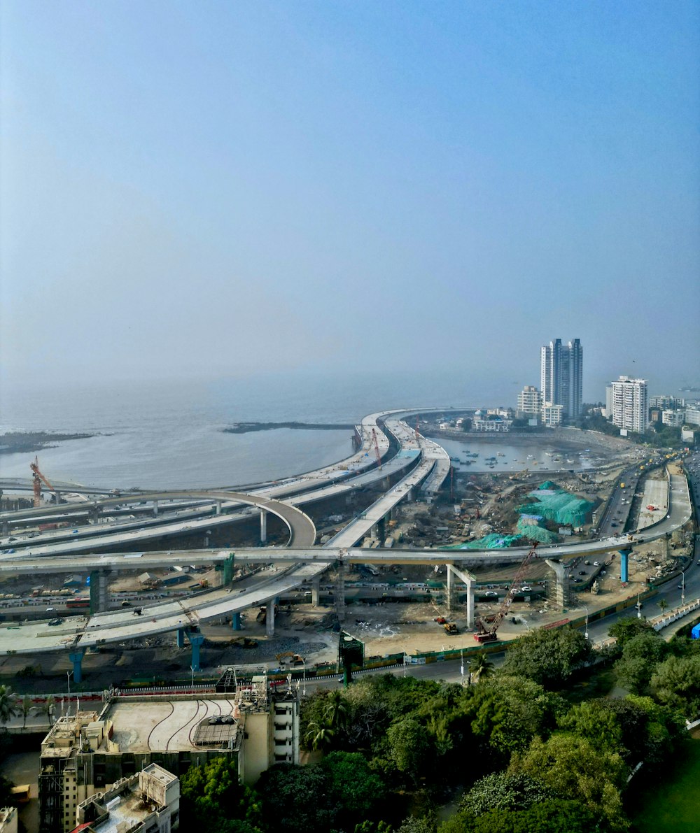 an aerial view of a highway near a large body of water