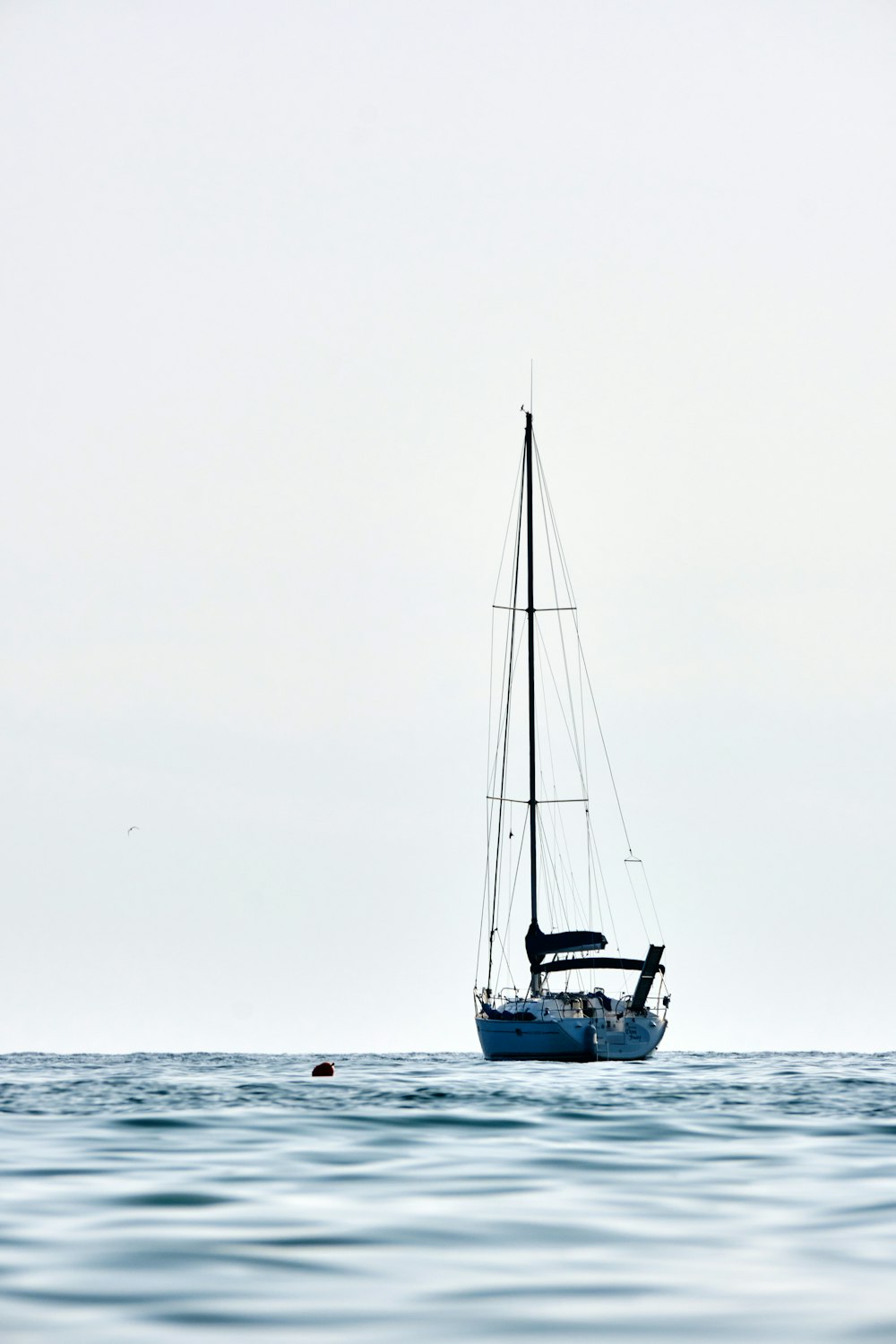 a sailboat floating on top of a body of water