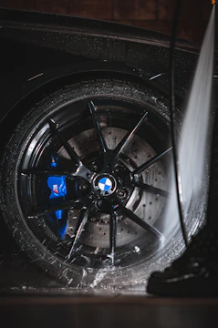 a close up of a car tire with a spray of water on it