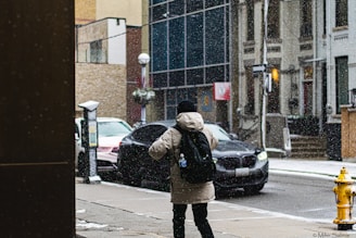 a woman standing on a sidewalk in the rain