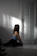 a woman sitting on the floor in front of a door